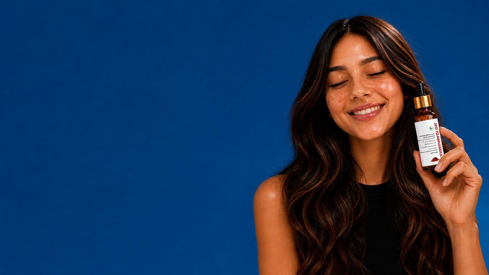 Woman holding a bottle of skincare product against a blue background